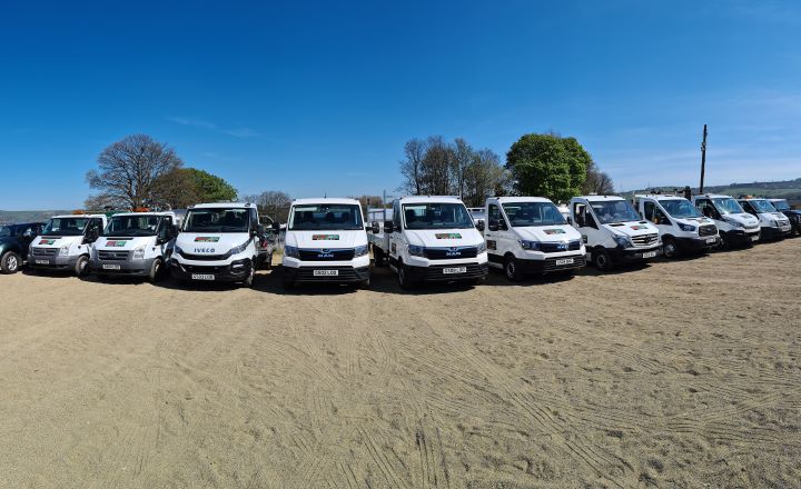 The G&S Toilet Hire fleet of white service vans and tipper trucks lined up
