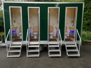 A four-bay green G&S luxury toilet trailer with pull-out steps