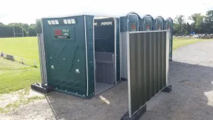 A green G&S event toilet and urinal block with surrounding fencing