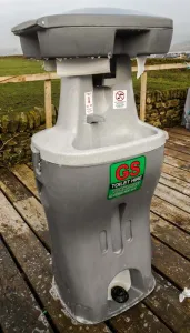 A freestanding grey G&S hand-wash station